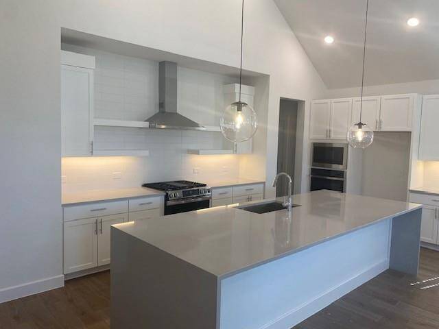 Decorative floating shelves and waterfall edge island in the kitchen