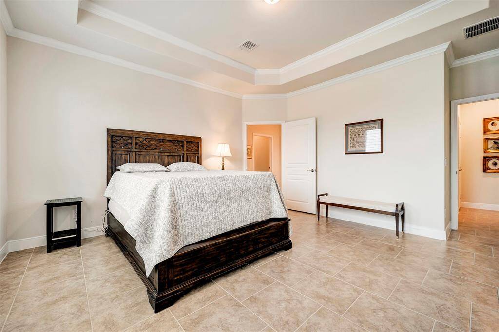 Spacious primary bedroom easily fits a king-size bed and large furniture.