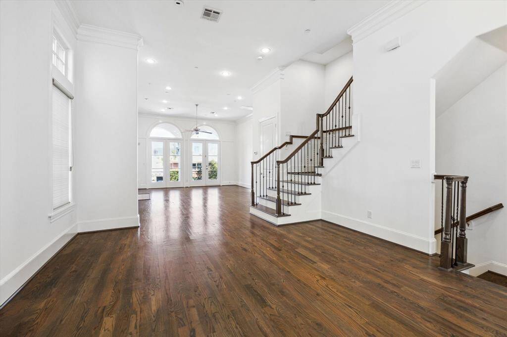 Family dining area facing north balcony accessible through double doors with arched transoms.