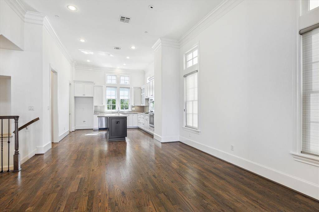 View from dining area toward kitchen. First door on left is powder bath. Second door on left is pantry.