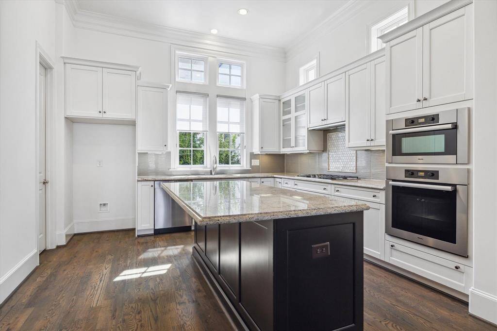 Well appointed granite clad kitchen with great storage, stainless steel Miele appliances, gas range, walk-in pantry, excellent workspace and large island with additional storage and breakfast ledge.