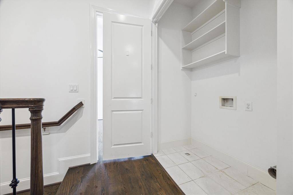 Third floor laundry room between primary and secondary bedrooms.