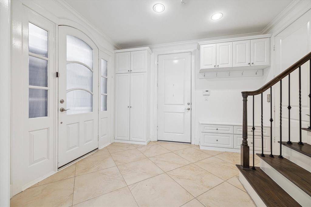 Generous, elegant light-filled foyer offers coat closet and mudroom storage from garage and convenient access to elevator that services all four floors of the inviting abode. Welcome to a world of recently painted, tasteful appointments and neutral finishes.