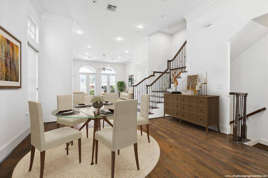 Virtually staged, bathed in natural light, open plan second floor with high ceilings, hardwood floors, handsome moldings, transoms above all windows, island kitchen, dining room, family room, powder bath and front balcony.