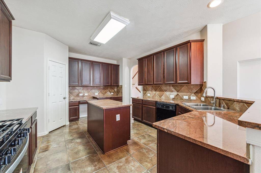 Granite countertops with new microwave and gas stove. 42 in cabinets and a great walk in pantry.