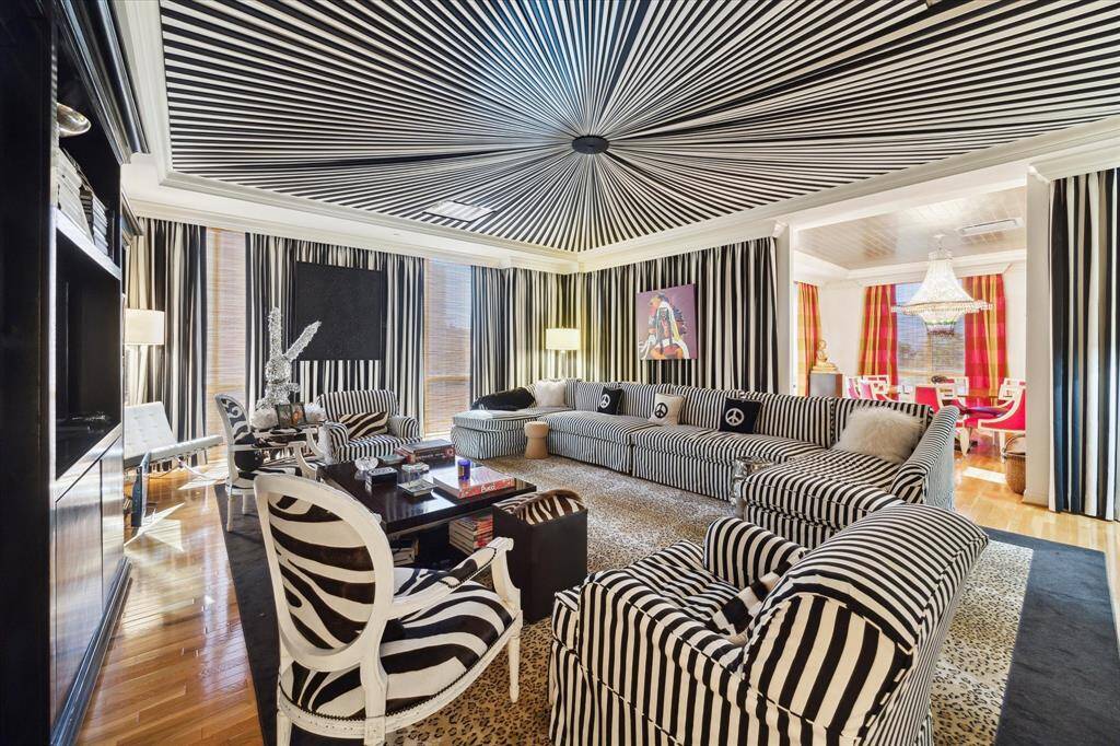 Another view of the vibrant, custom family room with built-ins and hard wood floors.