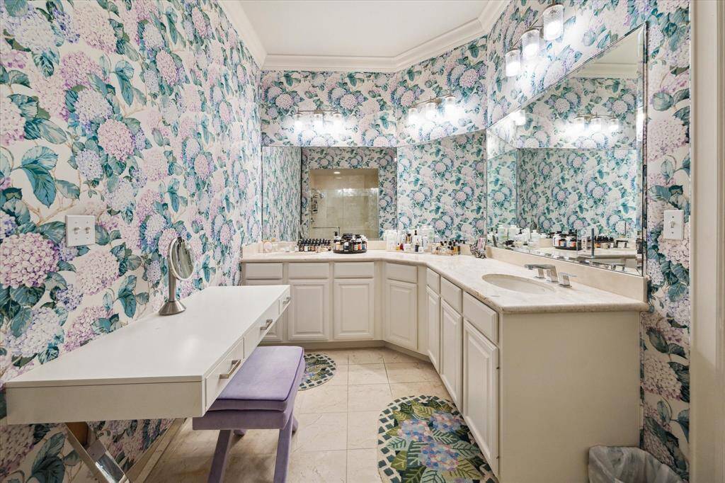 The en-suite primary bathroom has dual sinks, a vanity area, shower and bathtub. And it is adjacent to the primary closet.