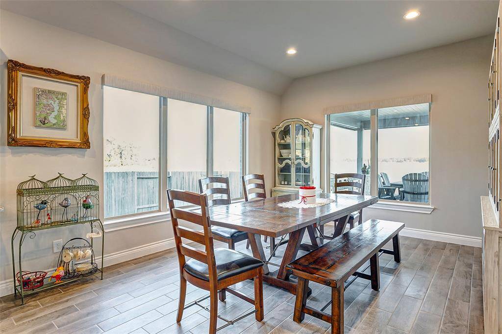 Spacious and inviting living room with large windows that frame tranquil lake views