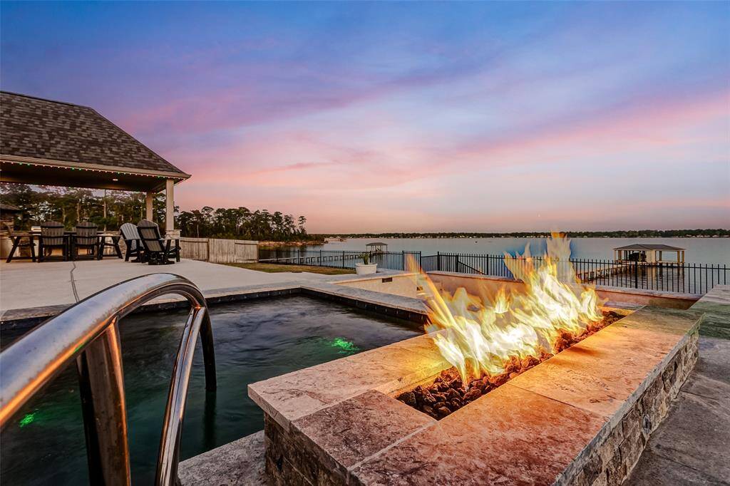 An entertainer's dream with a sport pool, sit in fire pit and an outdoor kitchen