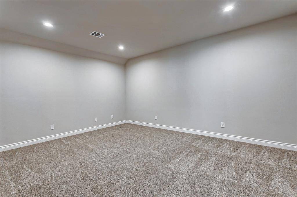 Virtually staged versatile/media room.