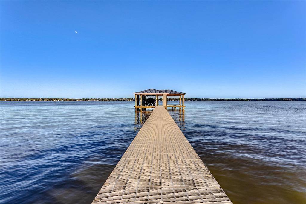 Covered boat house w/upgraded R-panel metal roof, a boat lift and two jet ski lifts