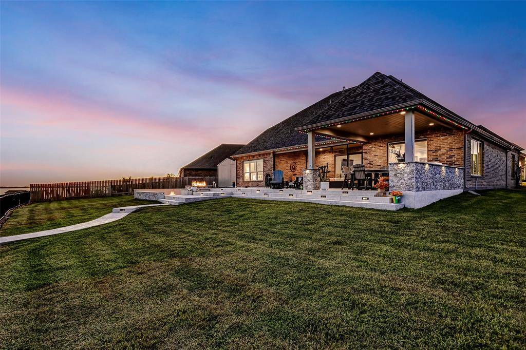 An entertainer's dream with a sport pool, sit in fire pit and an outdoor kitchen
