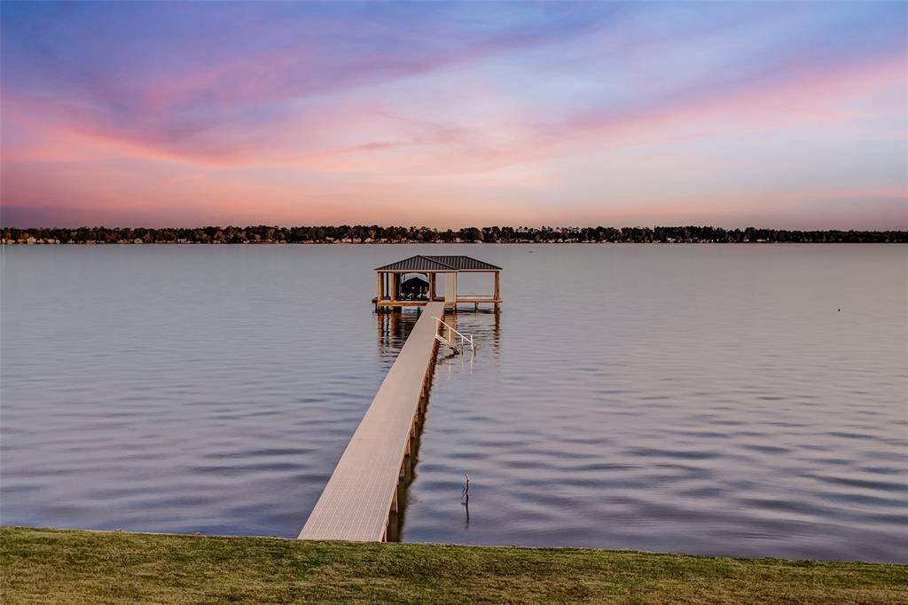 Breathtaking lakefront location with a private boathouse and unobstructed views of Lake Houston, perfect for enjoying sunsets