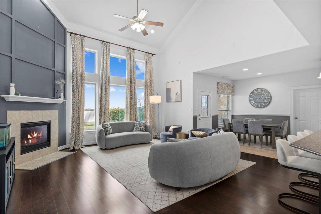 Experience the drama of a two-story wall of windows, offering breathtaking views of the fabulous water! The spacious family area boasts high ceilings with elegant crown molding, complemented by custom window coverings and more!