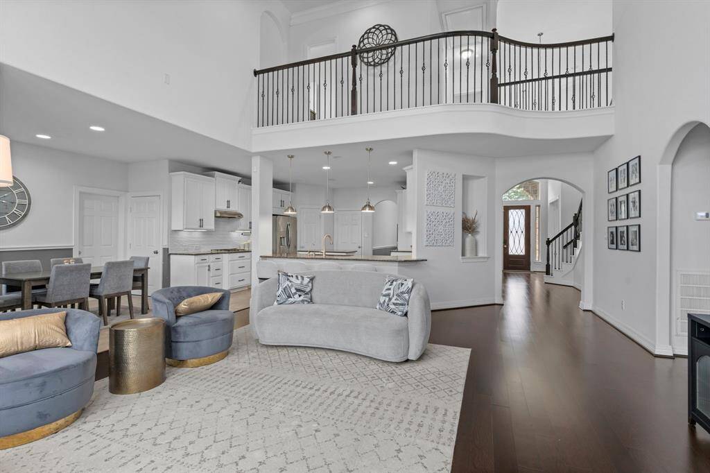 Marvel at the stunning view from the upstairs iron catwalk, complemented by an elegant arched doorway, art niches, and all the custom features that give this home its undeniable Wow Factor! The expansive family area seamlessly flows into the exceptional gourmet kitchen and inviting casual dining space.