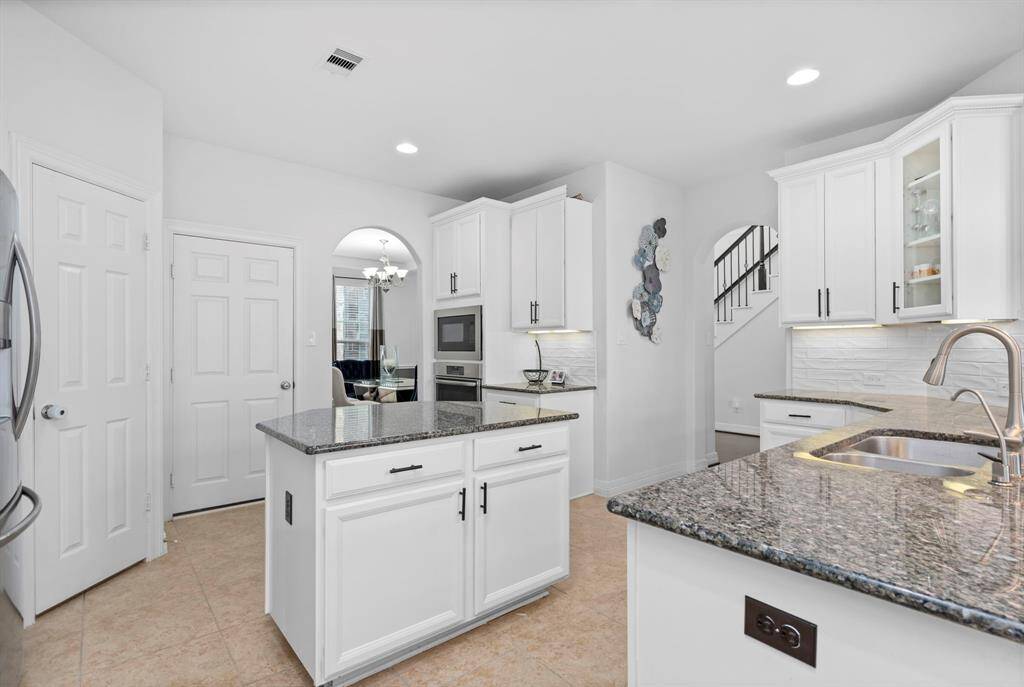 An impressive island perfect for all your baking and storage needs! And just wait until you open the door to your massive walk-in pantry—it's a dream come true!
