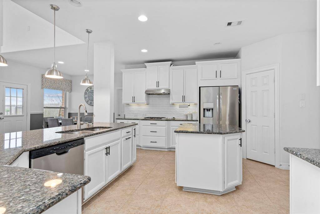 Featuring a sleek built-in stainless-steel gas range, complemented by a convenient bump-out cabinet below for all your pots and pans!