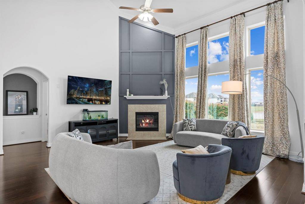 The family area boasts a stunning custom fireplace, perfect for cozying up during those cool Texas evenings. Down a private hallway, you'll discover the serene Owner's Retreat, tucked away for ultimate privacy and relaxation!