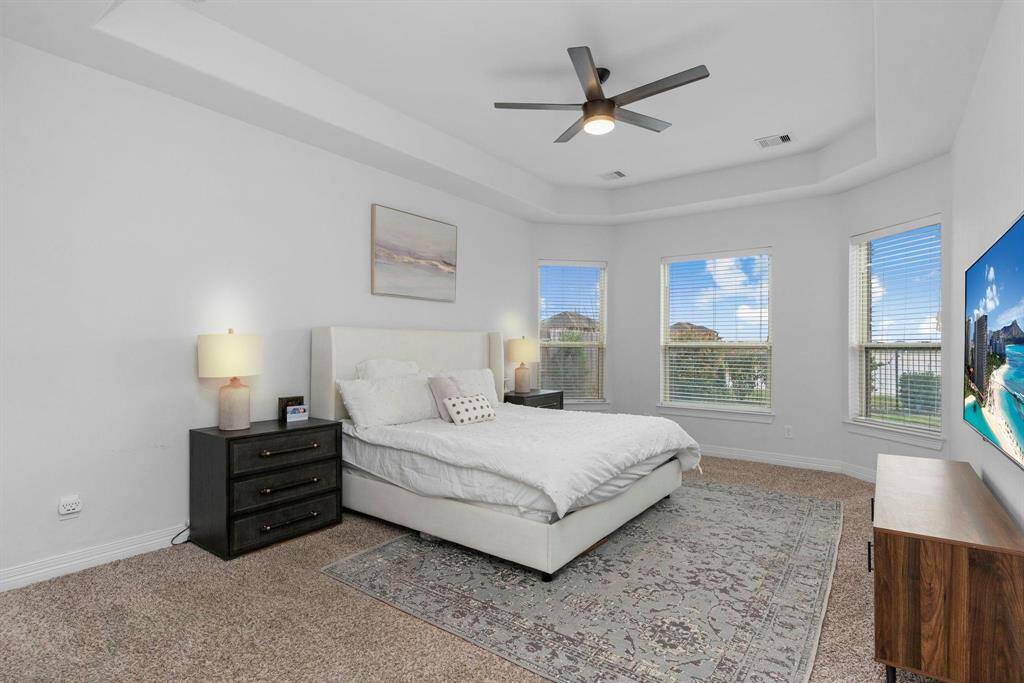 The Owner's Suite is perfectly tucked away downstairs, offering the privacy you desire. With high tray ceilings, it creates an elegant and spacious retreat!
