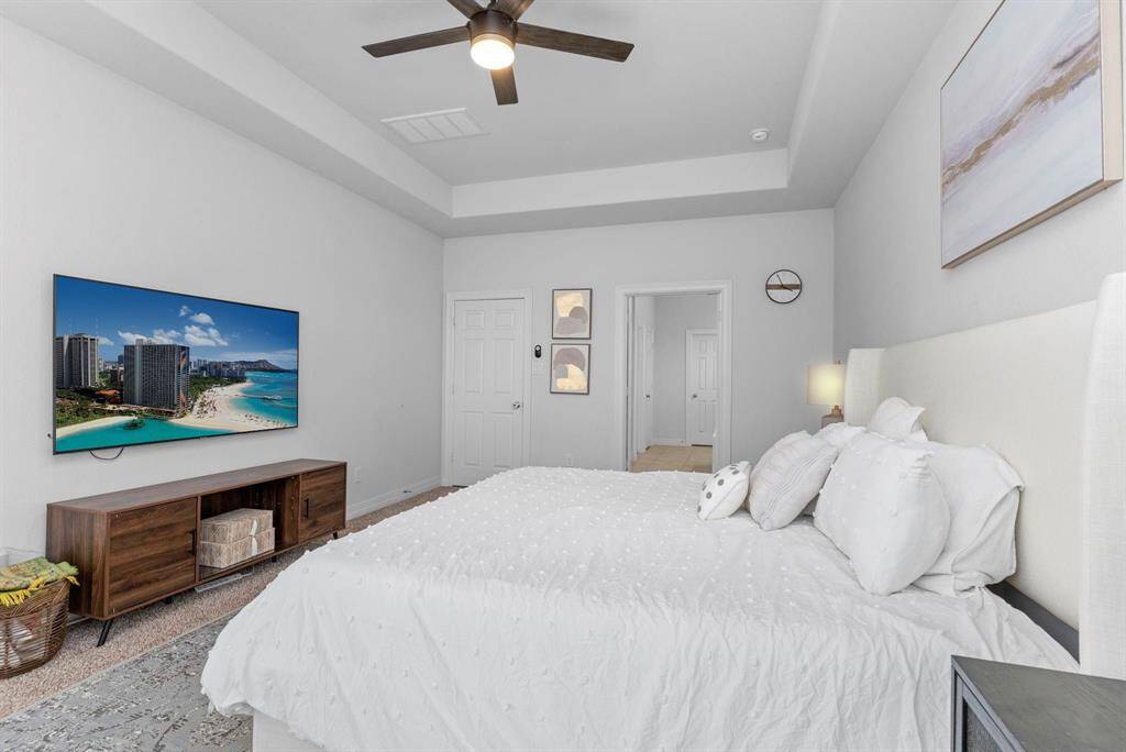 French doors lead to the luxurious spa-like Owner's Bathroom, thoughtfully designed with dual spaces for ultimate relaxation and convenience.