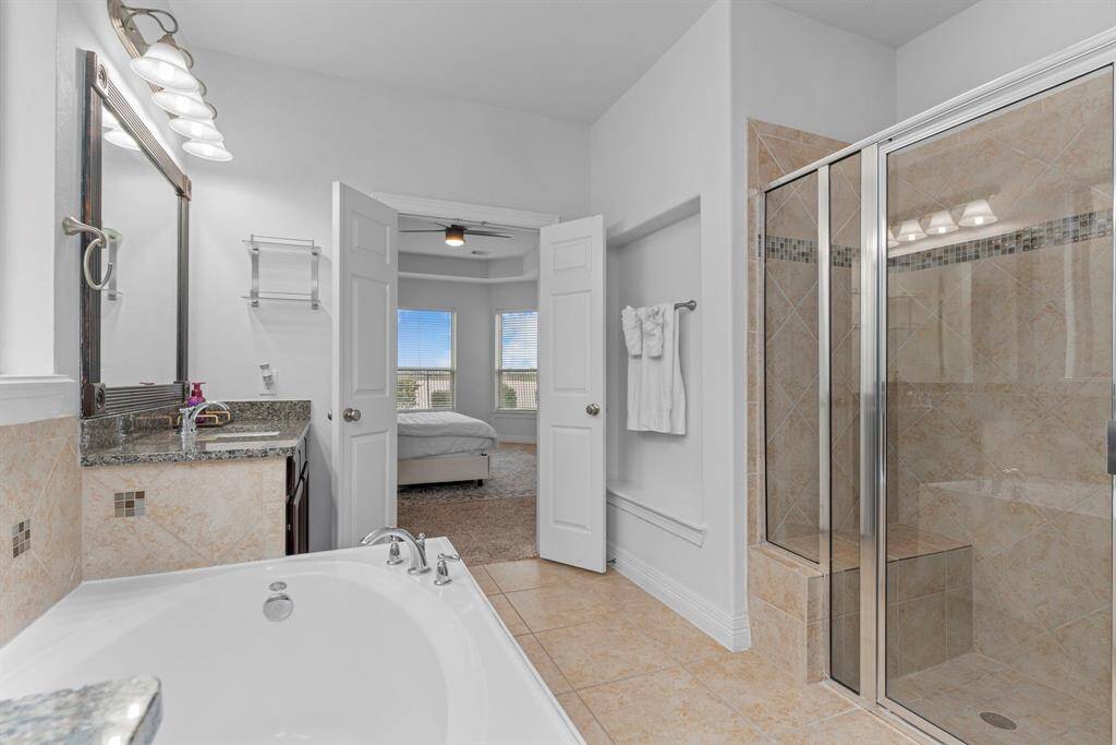 Indulge in the spacious shower, complete with a comfortable sitting bench for ultimate relaxation.