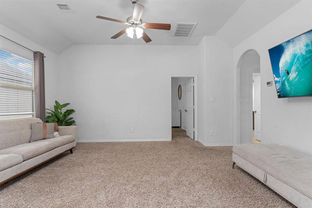The game room features high ceilings, offering plenty of space for fun and entertainment—imagine a pool table in here if this were my home!