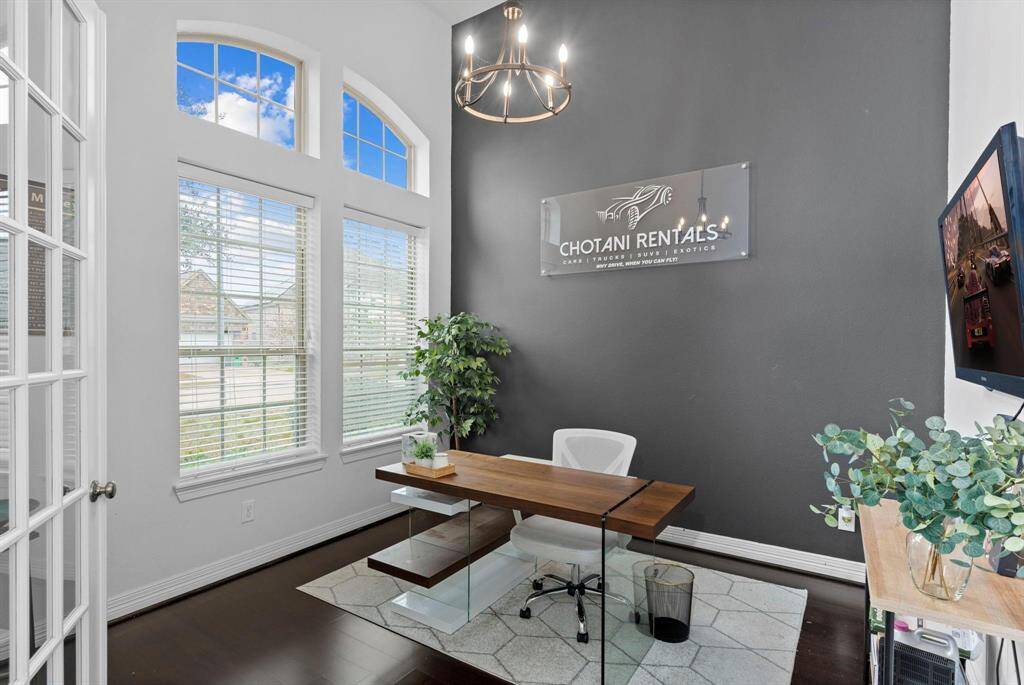 The perfect home office, thoughtfully tucked away from the main living areas! With high ceilings and custom transom windows, it’s filled with natural light, creating an ideal space to work from home!