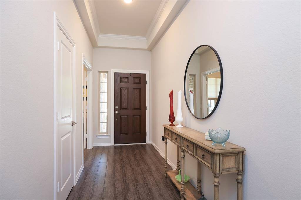 Elevated ceilings with crown molding. Entry door with sidelight.
