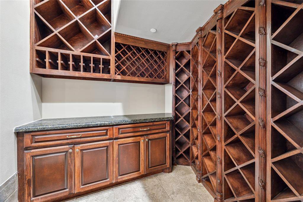 Discover the elegance of your own wine cellar, featuring wooden racks and ample storage space, perfect for showcasing your collection.