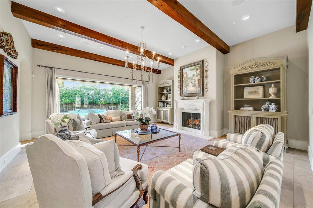 Formal living room with backyard views and gas fireplace.