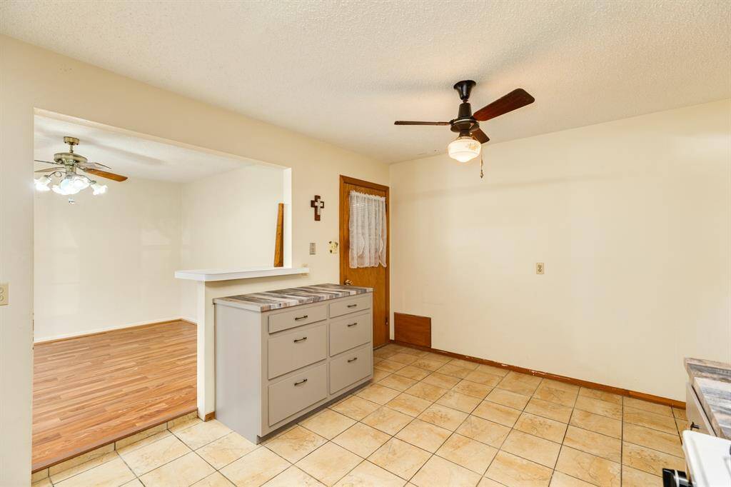Kitchen showing dining room and back door