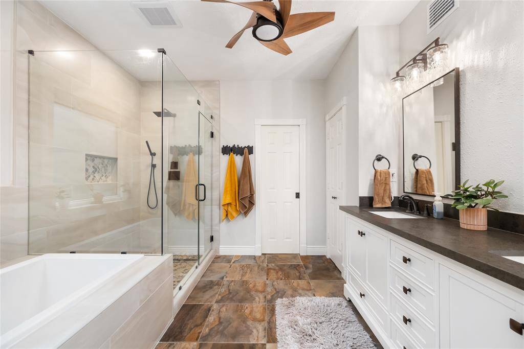 The Primary Bathroom features an impressive walk-in shower, soaking tub, and double sinks
