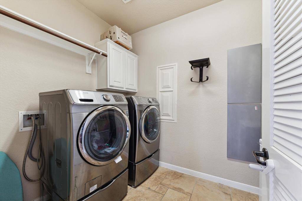 Utility room adjacent to the kitchen and close to the backyard and the pool for max functionality