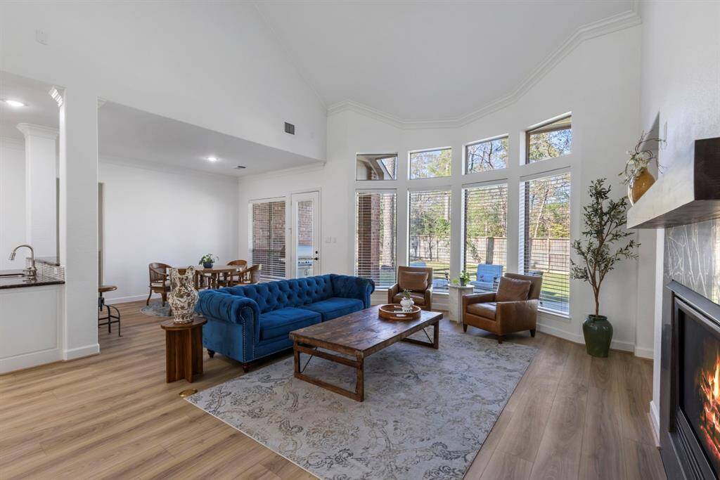 Sunlit living space with large windows and cozy fireplace, perfect for making memories.
