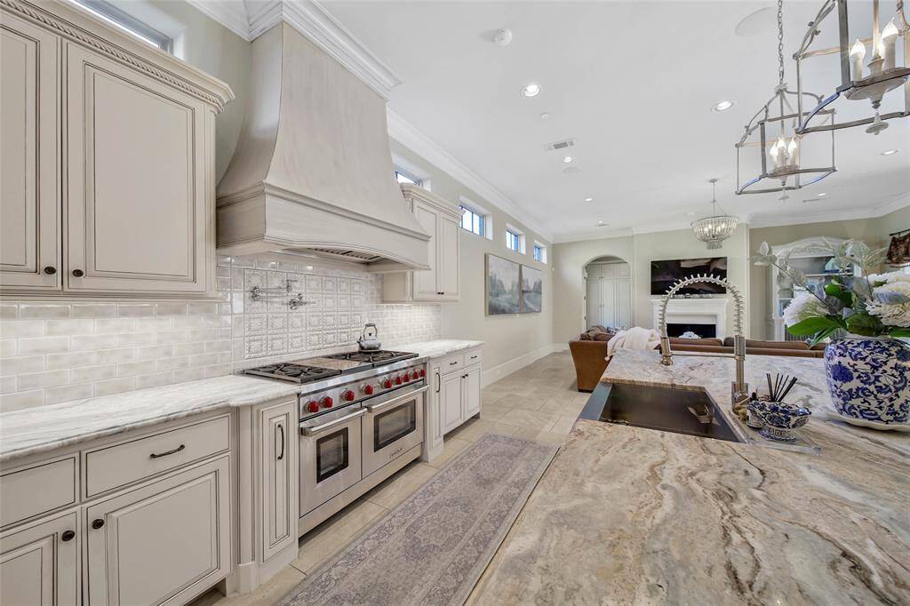 Expansive kitchen with wolf range, spacious island, and ample amount of storage for all of your cooking essentials.