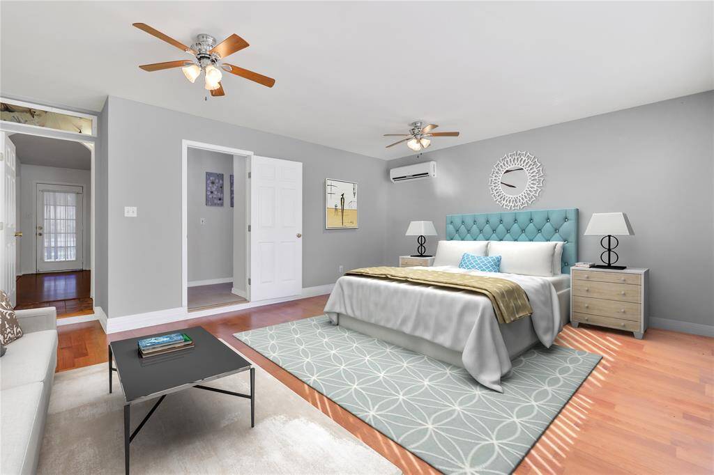 The primary bedroom offers plenty of space to comfortably fit a king-sized bed along with a cozy sitting area, creating the perfect retreat for relaxation and rest.