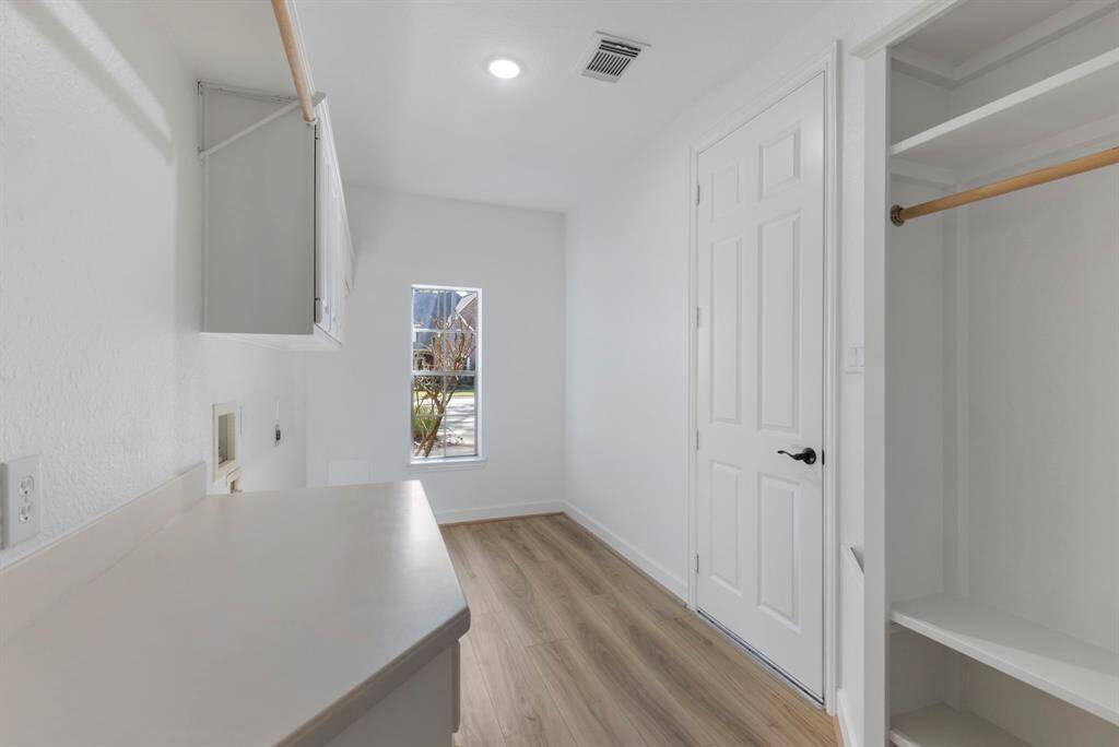 Spacious laundry room with modern design and ample storage for your laundry essentials.