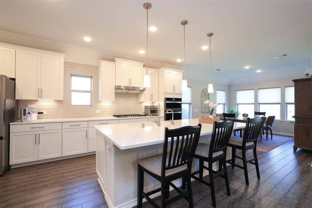 Upgraded kitchen cabinetry and pendant lighting