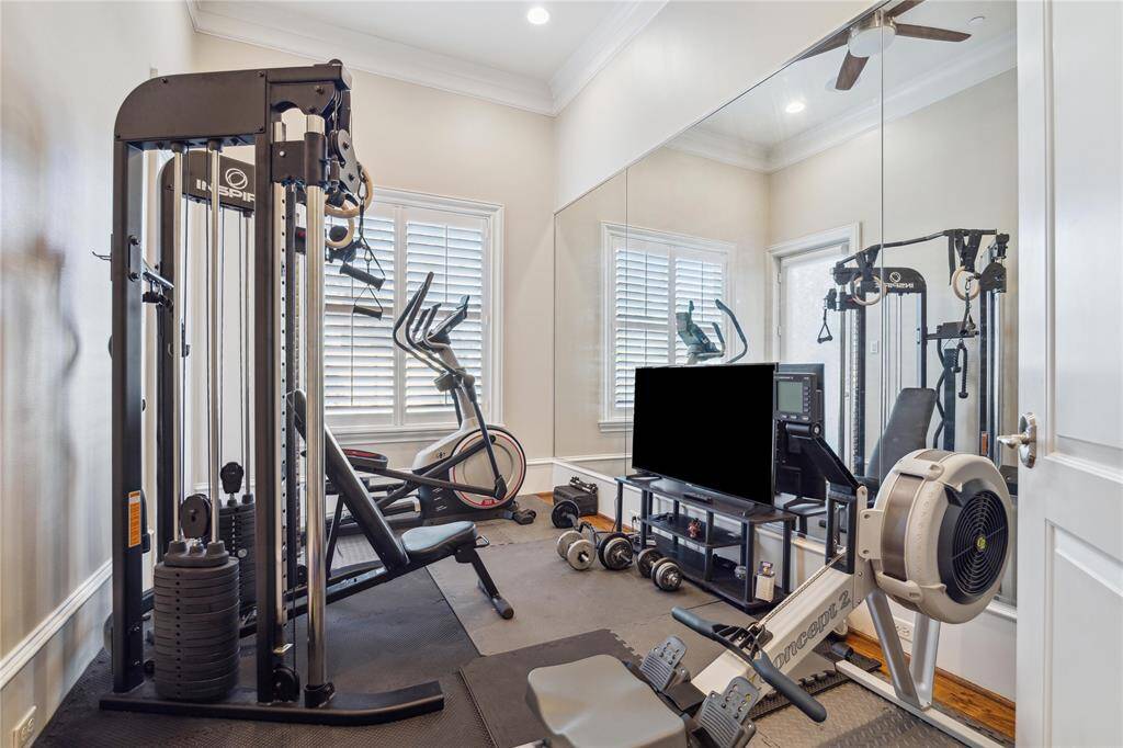 This bright home gym features, mirrored wall, and ample natural light—perfect for staying fit in the comfort of your own home.