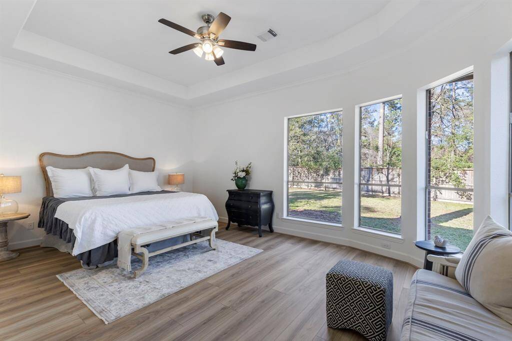 Wake up to nature's embrace in this serene primary bedroom retreat.