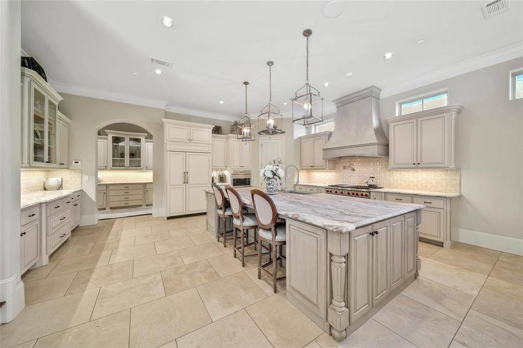 Expansive kitchen with wolf range, spacious island, and ample amount of storage for all of your cooking essentials.