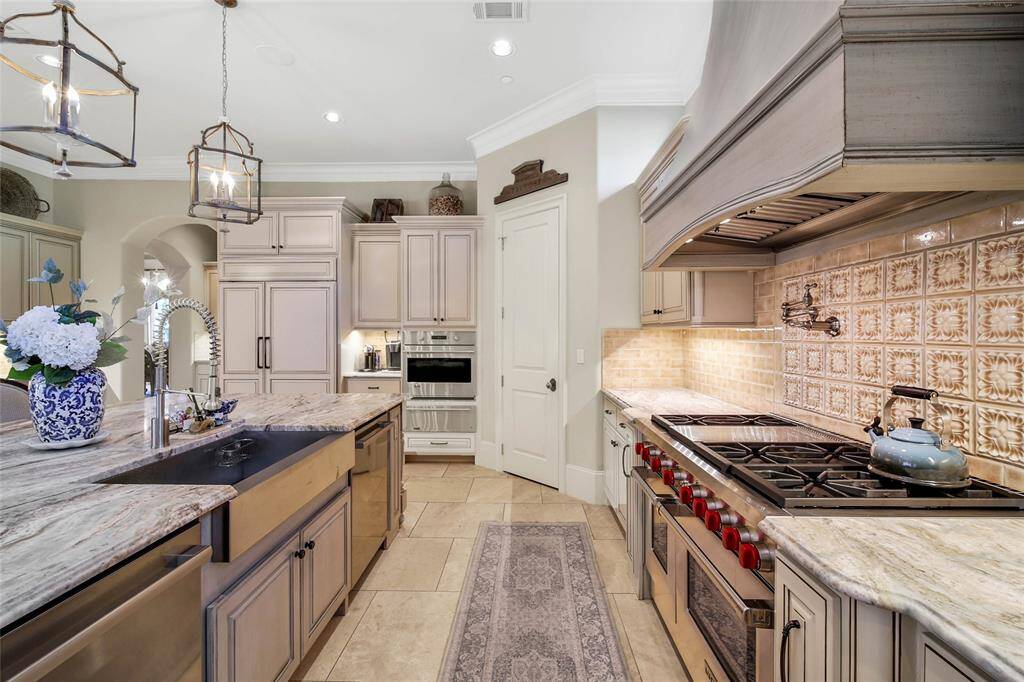 Expansive kitchen with wolf range, spacious island, and ample amount of storage for all of your cooking essentials.