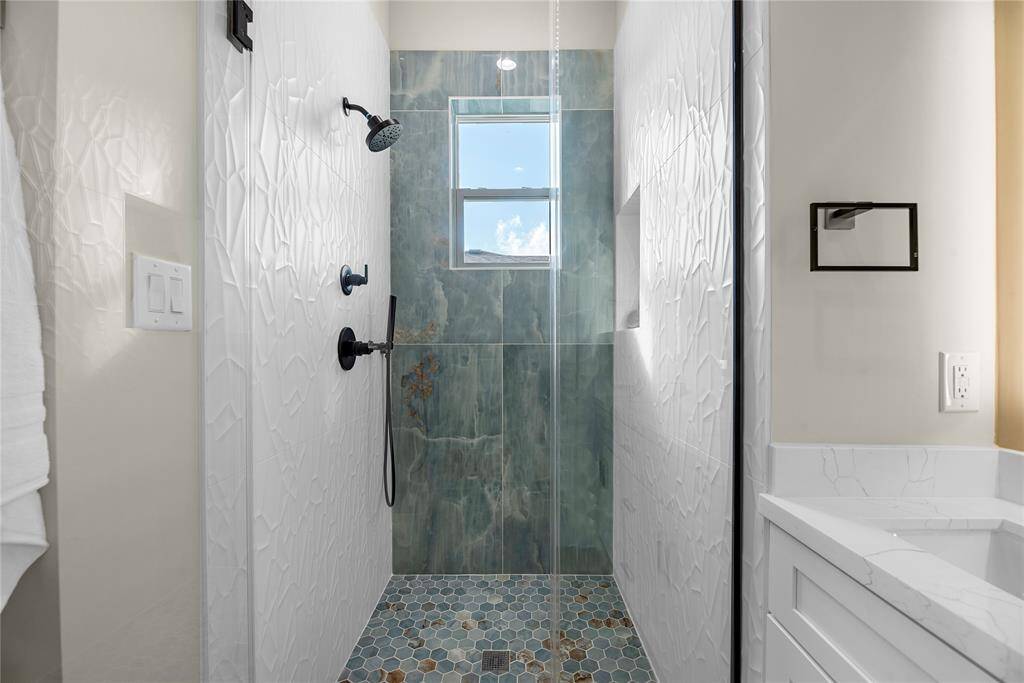 Look at the beautiful detail and color in the walk-in shower.