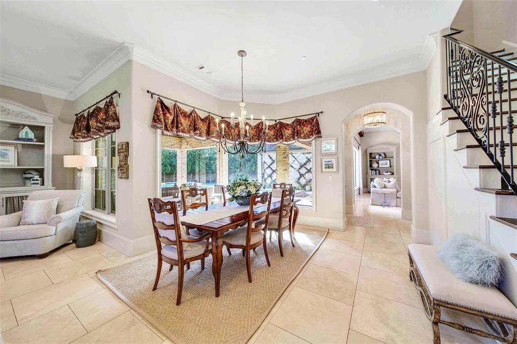 Spacious breakfast nook surrounded by windows and backyard views.