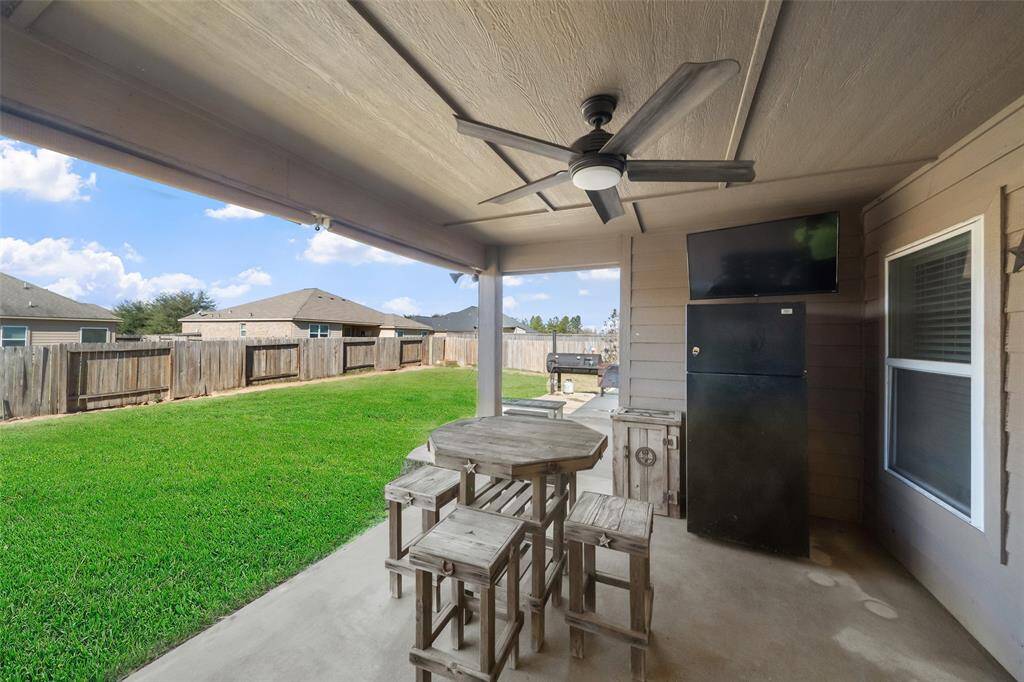Out back, there is a beautiful porch with a ceiling fan for the hotter days!