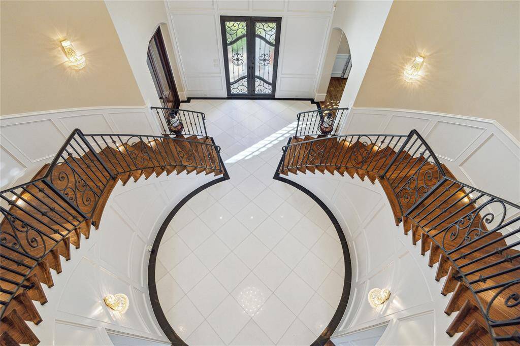 The bright, spacious foyer boasts polished floors and stylish lighting.