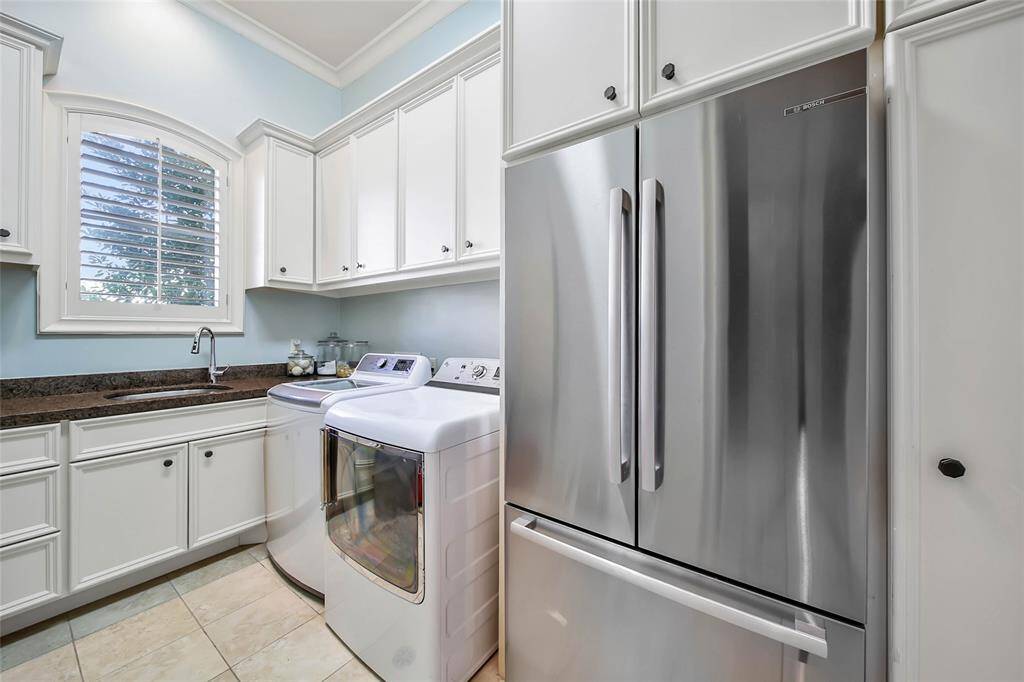 Utility room equipped with ample storage for all of your laundry essentials.