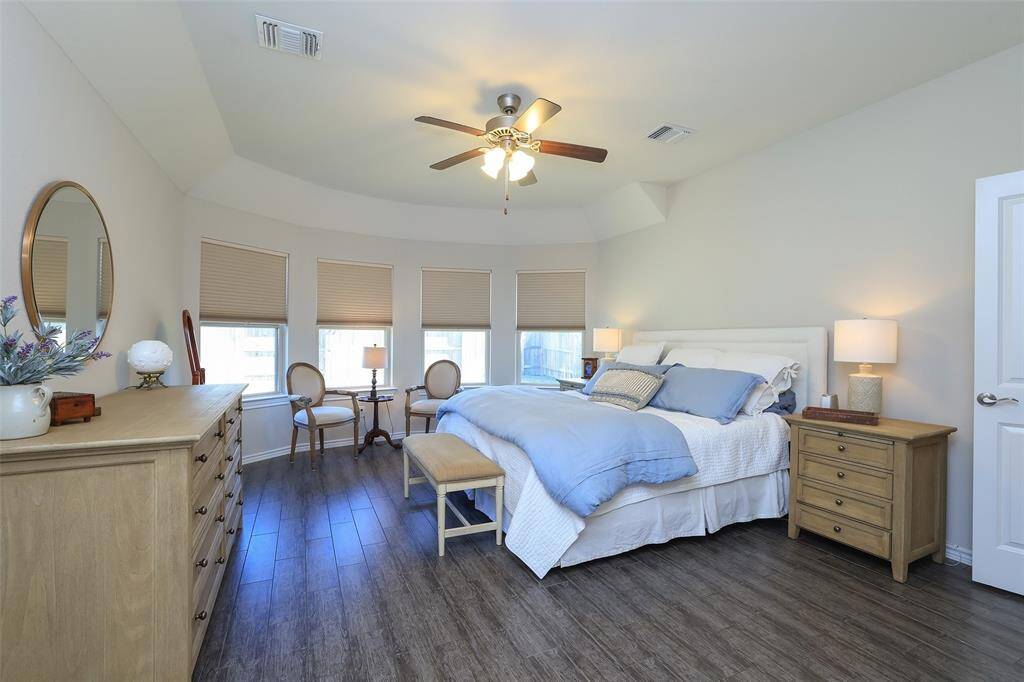 Such a pretty primary bedroom with bay window.