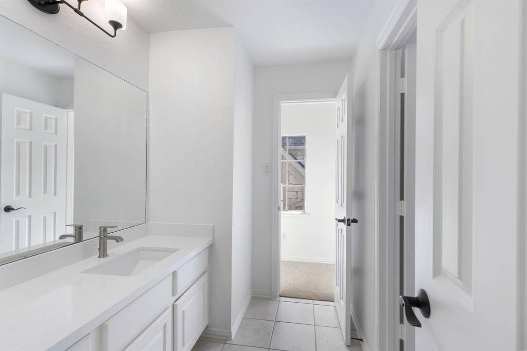 Jack and Jill bathroom leads effortlessly to a cozy, sunlit secondary bedroom retreats.