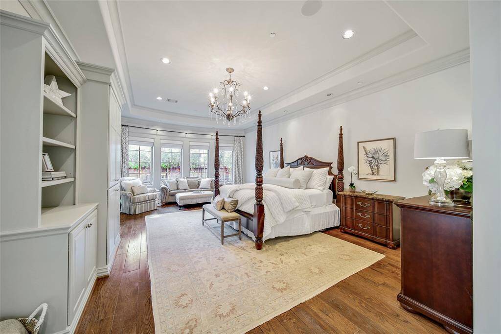 Vast primary suite featuring built-in shelves and a stunning ensuite bathroom.